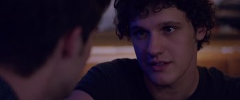 Movie still from “Alex Strangelove” (2018), directed by Craig Johnson – A young man sitting next to another young man in a room; Close Up shot, Over the shoulder angle