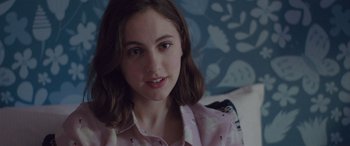 Movie still from “Alex Strangelove” (2018), directed by Craig Johnson – A young girl is sitting in a chair; Close Up shot, Over the shoulder angle