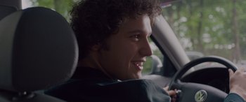 Movie still from “Alex Strangelove” (2018), directed by Craig Johnson – A man sitting in the drivers seat of a car; Close Up shot, Over the shoulder angle