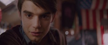 Movie still from “Alex Strangelove” (2018), directed by Craig Johnson – A young man's face in a dark room; Close Up shot, Over the shoulder angle