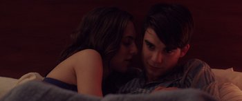 Movie still from “Alex Strangelove” (2018), directed by Craig Johnson – A man and a woman laying in bed together; Close Up shot, Over the shoulder angle