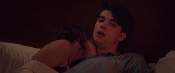 Movie still from “Alex Strangelove” (2018), directed by Craig Johnson – A man and a woman laying on a bed together; Close Up shot, Over the shoulder angle