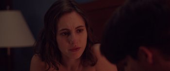 Movie still from “Alex Strangelove” (2018), directed by Craig Johnson – A woman looking at her reflection in a mirror; Close Up shot, Over the shoulder angle