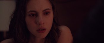 Movie still from “Alex Strangelove” (2018), directed by Craig Johnson – A young woman's face in the dark; Close Up shot, Over the shoulder angle