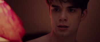 Movie still from “Alex Strangelove” (2018), directed by Craig Johnson – A young man's face in the dark; Close Up shot, Over the shoulder angle