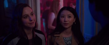 Movie still from “Alex Strangelove” (2018), directed by Craig Johnson – Two young women standing next to each other in a room; Close Up shot, Over the shoulder angle