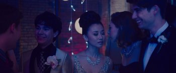 Movie still from “Alex Strangelove” (2018), directed by Craig Johnson – A group of people standing next to each other in a room; Close Up shot, Over the shoulder angle