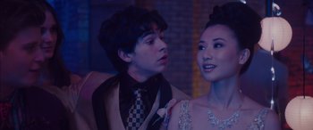 Movie still from “Alex Strangelove” (2018), directed by Craig Johnson – A man and a woman in formal wear looking at one another; Close Up shot, Over the shoulder angle