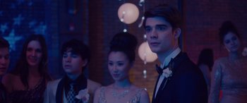 Movie still from “Alex Strangelove” (2018), directed by Craig Johnson – A group of people in formal wear posing for a picture; Close Up shot, Over the shoulder angle