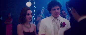 Movie still from “Alex Strangelove” (2018), directed by Craig Johnson – A man and a woman in formal wear at a party; Medium shot, Over the shoulder angle