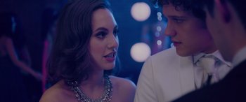 Movie still from “Alex Strangelove” (2018), directed by Craig Johnson – A man and a woman in formal wear looking at one another; Close Up shot, Over the shoulder angle