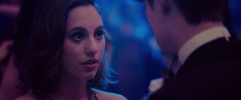 Movie still from “Alex Strangelove” (2018), directed by Craig Johnson – A young woman looking at a young man in a dark room; Close Up shot, Over the shoulder angle