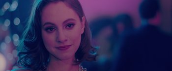 Movie still from “Alex Strangelove” (2018), directed by Craig Johnson – A woman's face in a purple light; Close Up shot, Over the shoulder angle