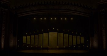 Movie still from “Ali Wong: Don Wong” (2022), directed by Nahnatchka Khan – A person standing in front of an empty stage; Extreme Wide shot, Low angle