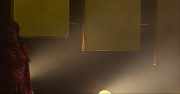 Movie still from “Ali Wong: Don Wong” (2022), directed by Nahnatchka Khan – A light shines through a window with a yellow curtain; Medium shot, Low angle