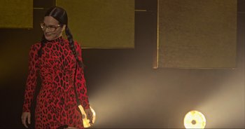 Movie still from “Ali Wong: Don Wong” (2022), directed by Nahnatchka Khan – A woman in a red and black leopard print dress; Medium shot, Low angle