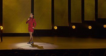 Movie still from “Ali Wong: Don Wong” (2022), directed by Nahnatchka Khan – A woman standing on a stage holding a microphone; Extreme Wide shot, High angle