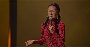 Movie still from “Ali Wong: Don Wong” (2022), directed by Nahnatchka Khan – A woman in a red and black dress holding a microphone; Close Up shot, High angle