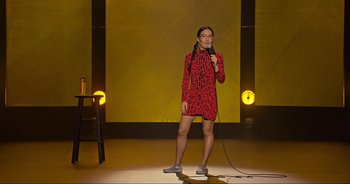 Movie still from “Ali Wong: Don Wong” (2022), directed by Nahnatchka Khan – A woman standing on a stage holding a microphone; Wide shot, High angle
