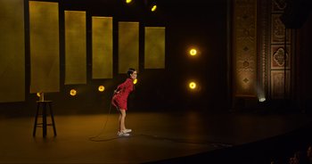 Movie still from “Ali Wong: Don Wong” (2022), directed by Nahnatchka Khan – A woman standing on a stage holding a microphone; Extreme Wide shot, High angle