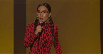Movie still from “Ali Wong: Don Wong” (2022), directed by Nahnatchka Khan – A woman in a red and black dress holding a microphone; Close Up shot, High angle