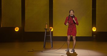Movie still from “Ali Wong: Don Wong” (2022), directed by Nahnatchka Khan – A woman standing on a stage holding a microphone; Wide shot, High angle