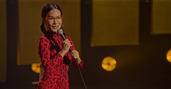 Movie still from “Ali Wong: Don Wong” (2022), directed by Nahnatchka Khan – A woman standing on a stage holding a microphone; Medium shot, High angle