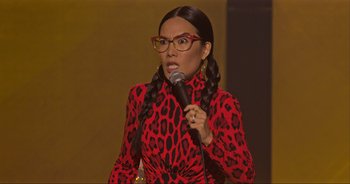 Movie still from “Ali Wong: Don Wong” (2022), directed by Nahnatchka Khan – A woman in a red and black dress holding a microphone; Close Up shot, Over the shoulder angle