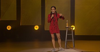 Movie still from “Ali Wong: Don Wong” (2022), directed by Nahnatchka Khan – A woman standing on a stage holding a microphone; Wide shot, High angle