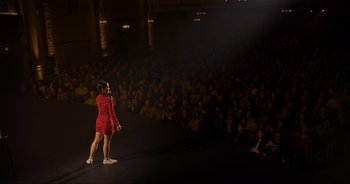 Movie still from “Ali Wong: Don Wong” (2022), directed by Nahnatchka Khan – A woman standing on a stage in front of an audience; Extreme Wide shot, High angle
