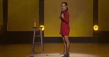Movie still from “Ali Wong: Don Wong” (2022), directed by Nahnatchka Khan – A woman standing on a stage holding a microphone; Wide shot, High angle