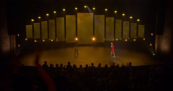 Movie still from “Ali Wong: Don Wong” (2022), directed by Nahnatchka Khan – A woman standing on a stage in front of an audience; Extreme Wide shot, High angle