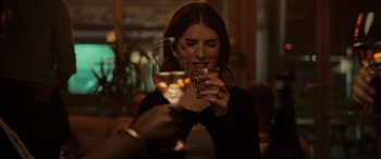 Movie still from “Alice, Darling” (2022), directed by Mary Nighy – A woman holding a wine glass and looking at her cell phone; Close Up shot, Over the shoulder angle