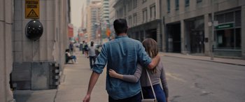 Movie still from “Alice, Darling” (2022), directed by Mary Nighy – A man and a woman walking down a street; Medium shot, Low angle