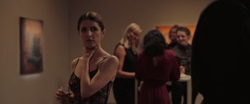 Movie still from “Alice, Darling” (2022), directed by Mary Nighy – A group of people standing around a room; Medium shot, Over the shoulder angle