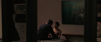 Movie still from “Alice, Darling” (2022), directed by Mary Nighy – A man and a woman sitting on a bed in a room; Medium shot, Over the shoulder angle