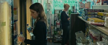 Movie still from “Alice, Darling” (2022), directed by Mary Nighy – Two women are standing in front of a counter; Medium shot, Over the shoulder angle