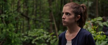Movie still from “Alice, Darling” (2022), directed by Mary Nighy – A woman standing in the middle of a wooded area; Close Up shot, Over the shoulder angle
