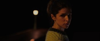 Movie still from “Alice, Darling” (2022), directed by Mary Nighy – A person wearing a sweater near a street light; Close Up shot, Over the shoulder angle
