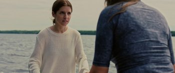 Movie still from “Alice, Darling” (2022), directed by Mary Nighy – A woman in a white sweater standing next to another woman; Medium shot, Over the shoulder angle