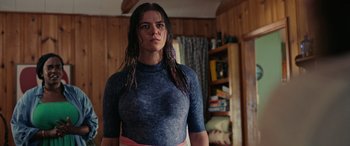 Movie still from “Alice, Darling” (2022), directed by Mary Nighy – A woman with wet hair standing in a living room; Medium shot, Low angle