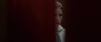 Movie still from “Alice, Darling” (2022), directed by Mary Nighy – A woman in a white hoodie looking at the camera; Close Up shot, Low angle