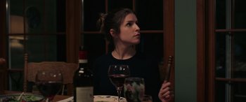 Movie still from “Alice, Darling” (2022), directed by Mary Nighy – A woman sitting at a table with a glass of red wine; Close Up shot, Over the shoulder angle