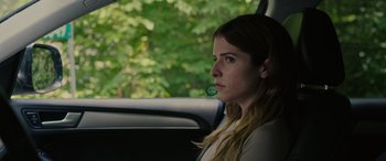 Movie still from “Alice, Darling” (2022), directed by Mary Nighy – A woman sitting in the back seat of a car looking out the window; Close Up shot, Over the shoulder angle