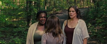 Movie still from “Alice, Darling” (2022), directed by Mary Nighy – A group of women standing next to each other on a dirt road; Medium shot, Over the shoulder angle