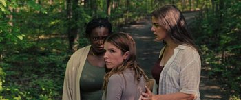 Movie still from “Alice, Darling” (2022), directed by Mary Nighy – A group of women standing next to each other on a dirt path; Medium shot, Over the shoulder angle