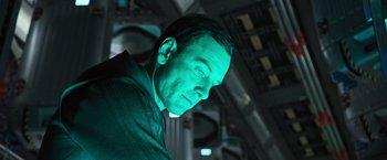 Movie still from “Alien: Covenant” (2017), directed by Ridley Scott – A person wearing a suit and tie; Close Up shot, Low angle