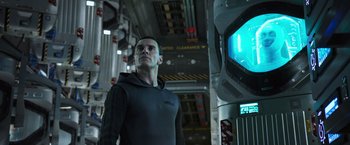 Movie still from “Alien: Covenant” (2017), directed by Ridley Scott – A man standing in front of a monitor in a room; Medium shot, Low angle