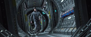 Movie still from “Alien: Covenant” (2017), directed by Ridley Scott – A man walking through a tunnel in an underground space; Wide shot, Low angle