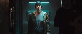 Movie still from “Alien: Covenant” (2017), directed by Ridley Scott – A person standing in a room wearing a hat and a jacket; Medium shot, Low angle